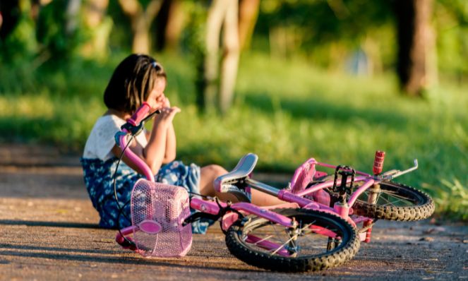 Girl that has fallen off her bike