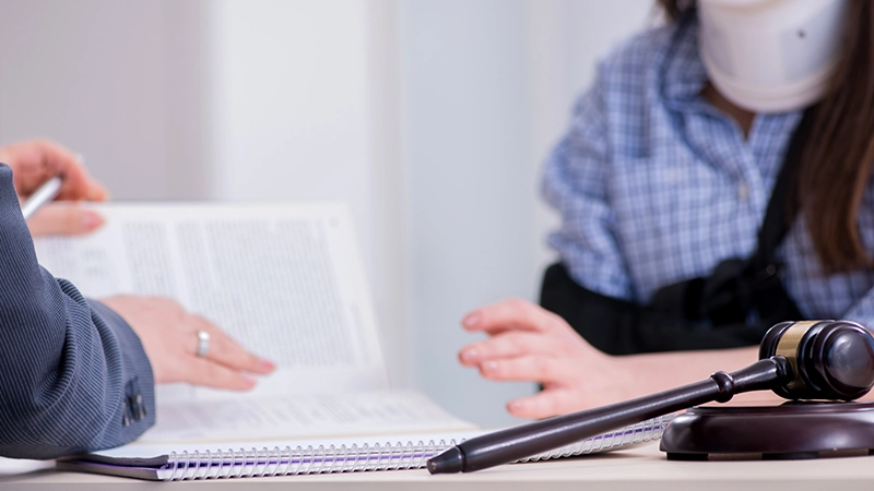 A lawyer and her client having legal consultation or personal injury lawsuit.