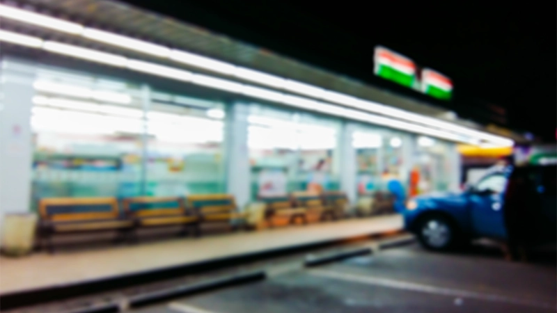 Blurred image in the front of the convenience store at night.