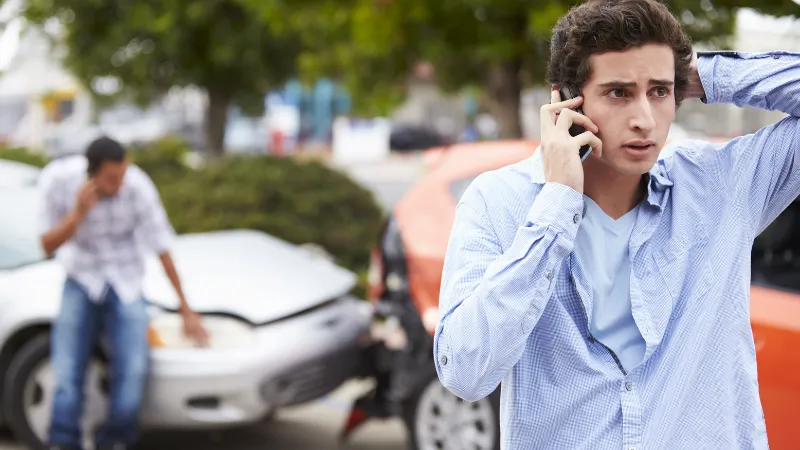 Teenage Driver Making Phone Call After accidents.
