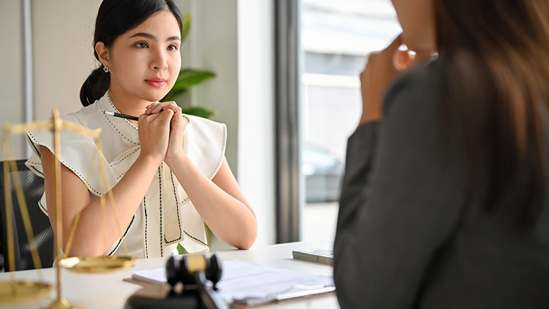 A female confesses her guilt in front of her lawyer.