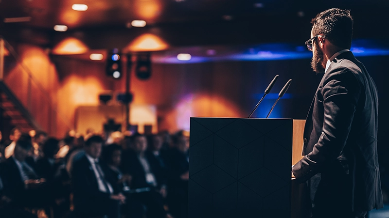Speaker giving a talk on corporate business conference.